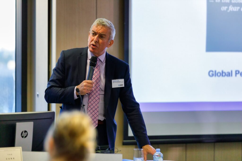 Charlie Allen presenting to an audience during a training session