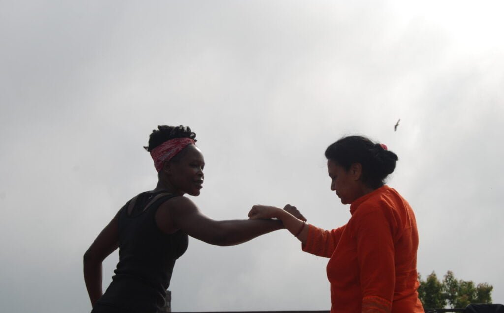 Two retreat participants embracing outdoors in Nepal