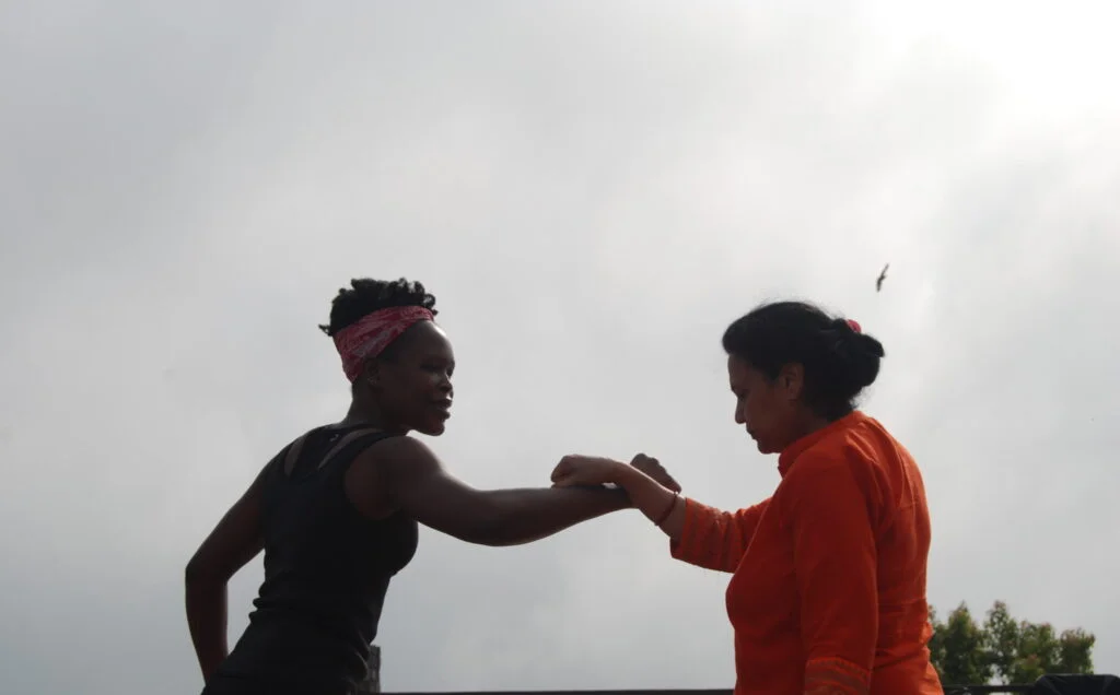 Two retreat participants embracing outdoors in Nepal